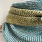 Close-up of aqua and green herringbone woven fabric 