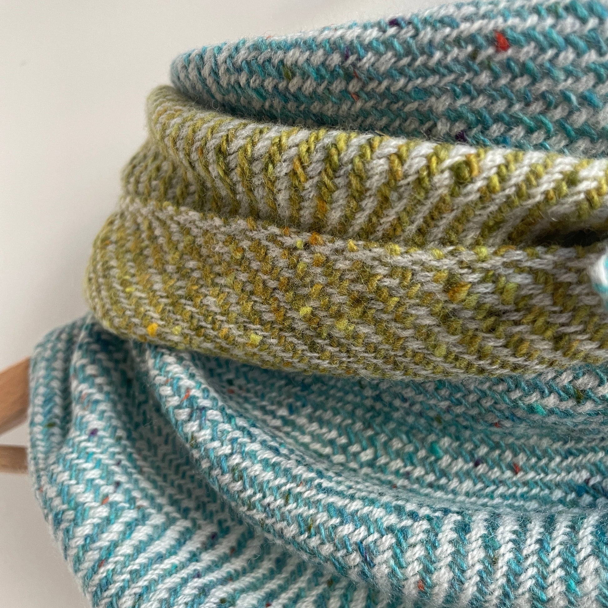 Close-up of aqua and green herringbone woven fabric 