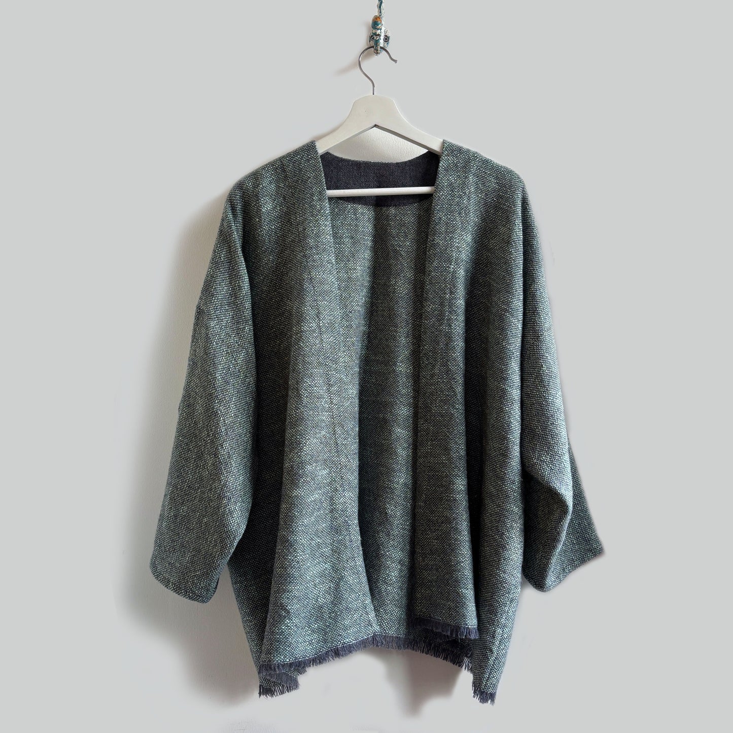 grey aqua sleeved cardigan with grey background